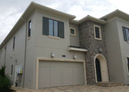 Custom home with stucco, stone veneer and precast accents - Reunion, Florida