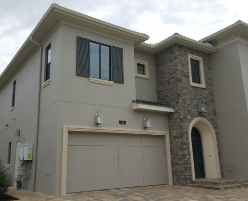 Custom home with stucco, stone veneer and precast accents - Reunion, Florida