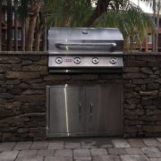Stone veneer summer kitchen with barbeque area and pavers - International Drive, Orlando