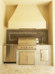 Stucco summer kitchen with custom tile backsplash